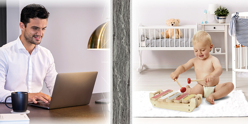 Young man working in one room with baby playing in the other room